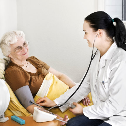 Senior lady having blood pressure check by a doctor