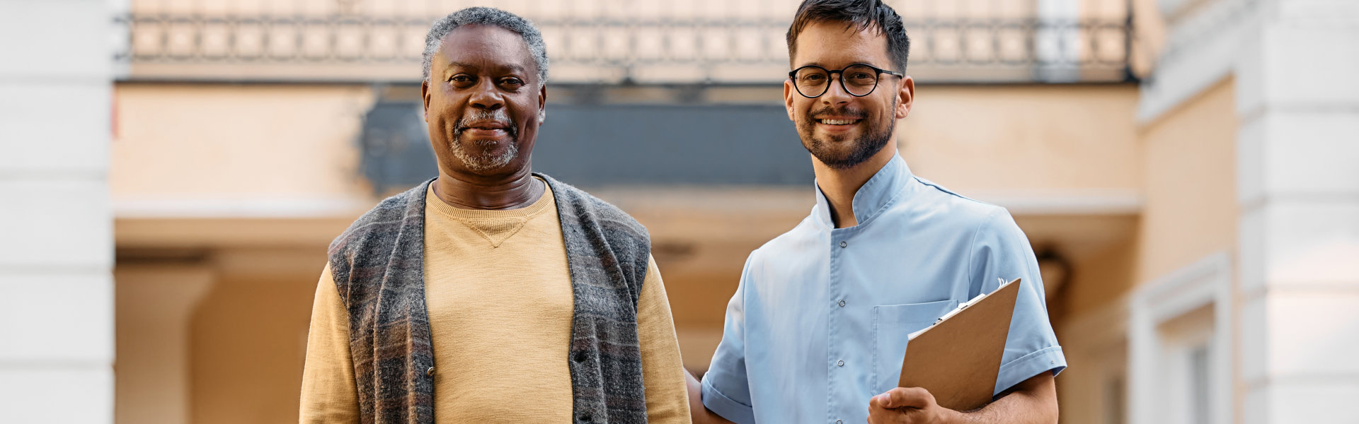 an elderly man and a man smiling together